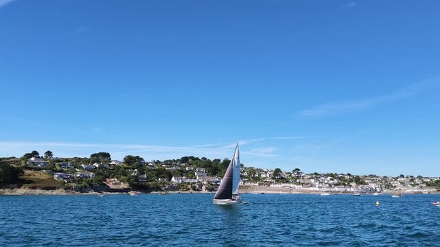 St Mawes Cornwall England UK. 13.08.2026. Video. a yacht under sail sailing past St Mawes a popular seaside resort in Cornwall UK.