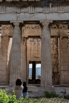 Athens Hephaestus Temple Greece Travel Tourism Ruins Ancient Landmark Agora. Two tourists taking photos in front of the Temple of Hephaestus
