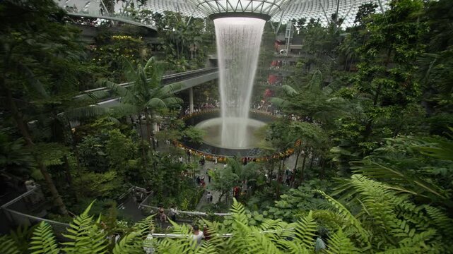 Scenic view of a Singapore airport featuring bionic architecture futuristic design tropical gardens and a spectacular indoor waterfall for travel and tourism in Asia