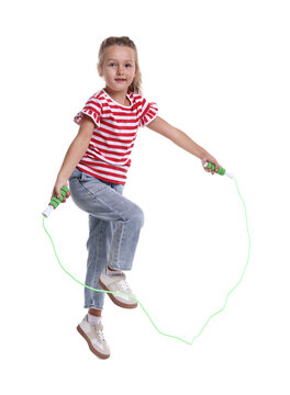 Cute little girl jumping with skipping rope on white background