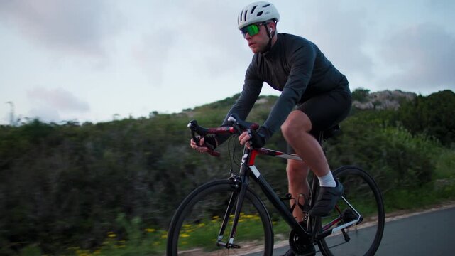 Cyclist riding bicycle in stunning natural landscape pedaling during training cardio workout active fitness sport and healthy lifestyle outdoors