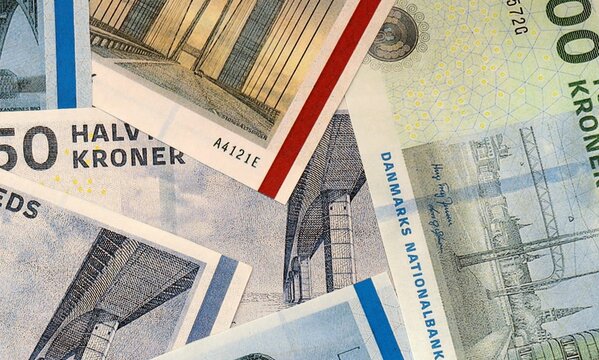 Danish krone money bills in pile on table. Denmark DKK currency cash close up