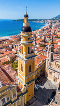 Aerial drone view of the Basilica of Saint-Michel in the old town of Menton on the coast of the Mediterranean Sea in the French Riviera