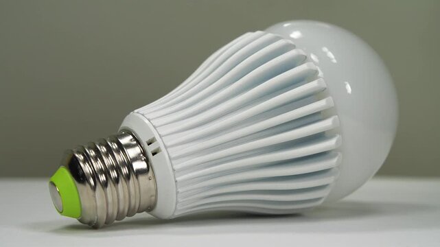 LED bulb with E27 base on a grey background