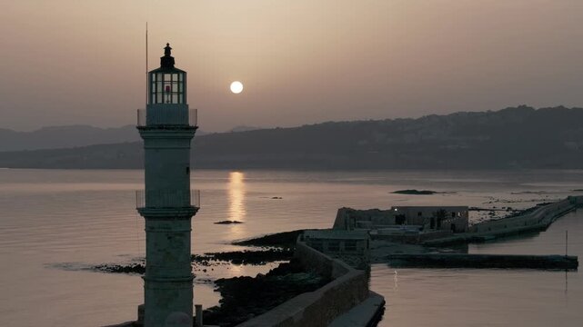  View of Chania with the amazing lighthouse, mosque, venetian shipyards, Crete, Greece.Waves crashing on lighthouse, Beautiful Greece and best scenic places - panorama