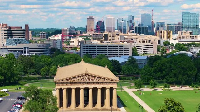 Iconic Greek temple replica surrounded by lush greenery in Centennial Park. Popular travel destination and cultural landmark in Nashville, Tennessee.