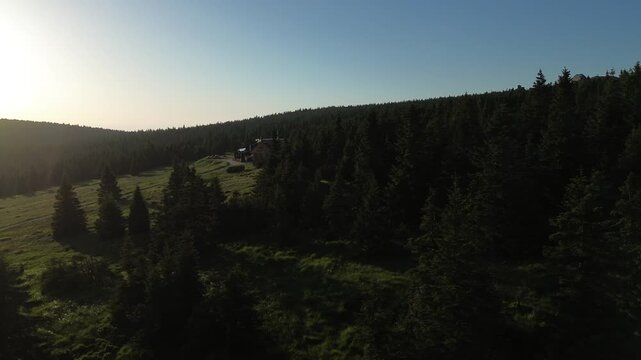 Aerial view of Voseck&aacute; bouda mountain shelter bathed in golden hour light, Karkonosze Mountains