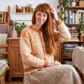 Portrait of a beautiful young red-haired woman at home