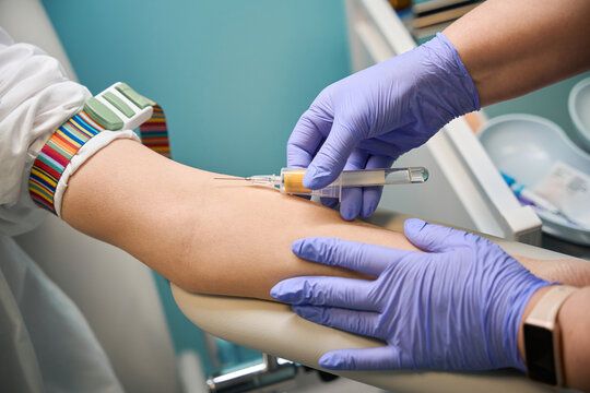 Medical professionals performing blood draw in clinic