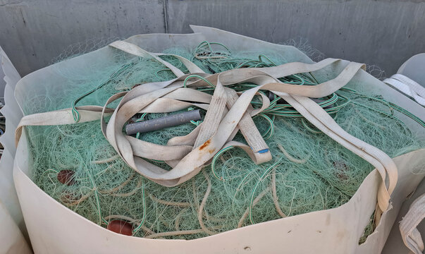 Top view of a bulk bag filled with fishing gear, including mesh, ropes, and float markers
