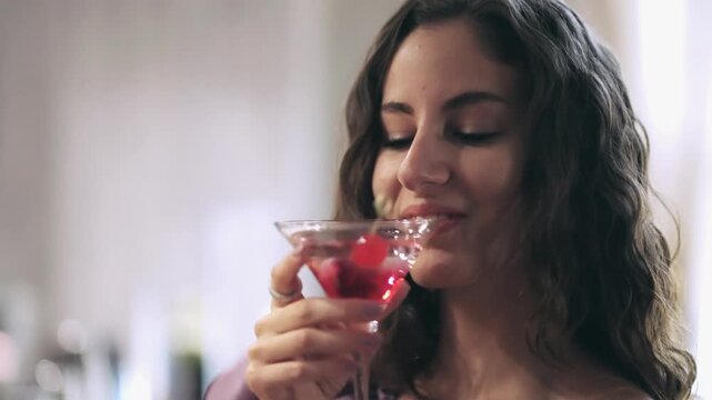 Smiling woman drinking cocktail glass enjoying a relaxed social celebration party event moment