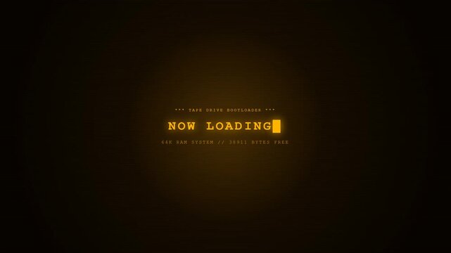 Retro amber computer screen displays 'NOW LOADING' with a blinking cursor. It mentions a tape drive bootloader and 64K RAM, evoking a nostalgic 1980s-era home computer startup sequence.