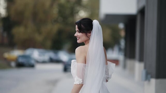 Happy smiling bride walk outdoors on a special wedding day, handheld shot