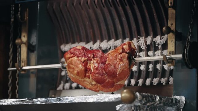 Juicy Ham Rotating on a Spit at a Christmas Market, Germany