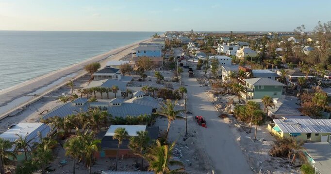 Ruined building in need of demolition or repair. Storm surge water and wind damaged house roof and collapsed walls after hurricane in Florida.