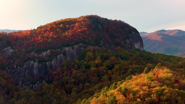 Scenic fall evening landscape of Looking Glass Rock in Appalachian mountains in North Carolina. Colorful forest stretches across autumn mountain terrain.
