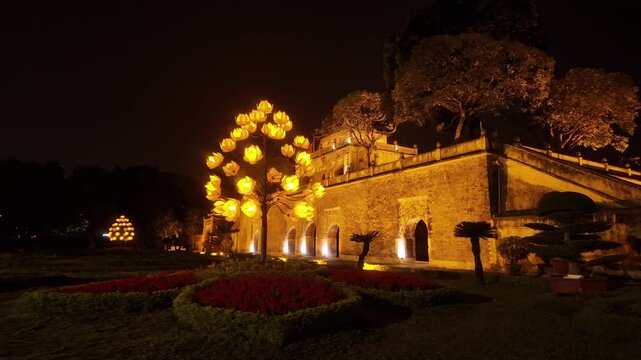 Illuminated Doan Mon Gate at Imperial Citadel of Thang Long with Glowing Lotus Tree at Night in Hanoi Vietnam - Stabilized Gimbal Shot Color Graded B-Roll