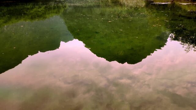Mirror Water Reflection Tilting Up to Mountain Karst Landscape in Trang An Ninh Binh Vietnam - Stabilized Gimbal Shot Color Graded B-Roll