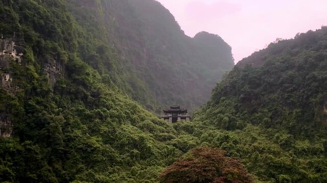 Ancient Temple Nestled Deep in Lush Limestone Karst Valley at Am Tien Cave Tuyet Tinh Coc in Ninh Binh Vietnam