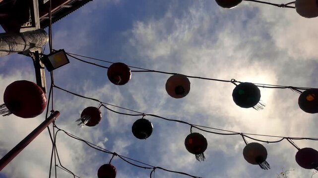 Low Angle View Looking Up at Hanging Red Lanterns Against Sunny Sky at Ho Quoc Pagoda Phu Quoc Vietnam: 4K Video