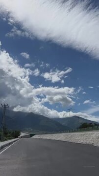 "Where the mountains touch the heavens, and the clouds whisper secrets to the wind."(Di mana gunung menyentuh surga, dan awan