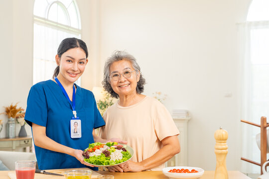 Caregiver preparing healthy meal for senior woman at home, elderly nutrition care and balanced diet concept, healthcare support with fresh ingredients, promoting wellness and daily healthy eating.