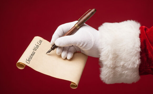 Santa Claus writing a Christmas wish list with a fountain pen on parchment paper