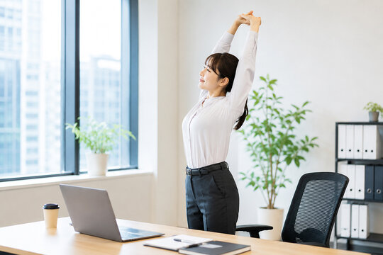 オフィスでリフレッシュする女性のストレッチ