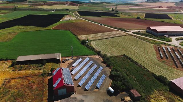 Aerial view of solar arrays at farm buildings in Avila Spain