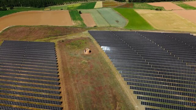 Angled aerial view of solar panel fields amid Avila cropland