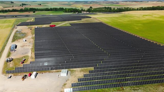Drone flyover of photovoltaic power station beside Avila farmland