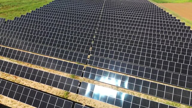 Drone glide above sunlit photovoltaic rows in Avila Spain