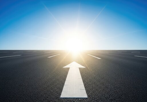 A wide asphalt road extends toward a bright sunlit horizon under a clear blue sky with a large white arrow painted on the smooth surface, summer, horizon, minimalist