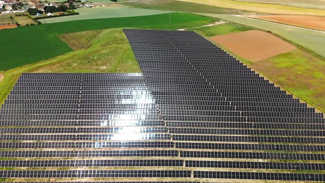 Rising drone view of solar power plant beside Avila cropland