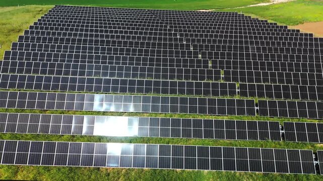 Drone descent above photovoltaic panels and farmland in Avila