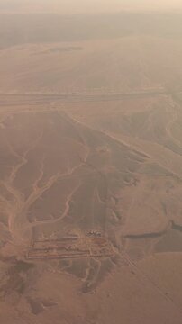 Aerial view of desert landscape with mountains and roads at sunset.Egypt. 