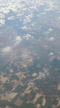 Aerial view of rural patchwork landscape with clouds above