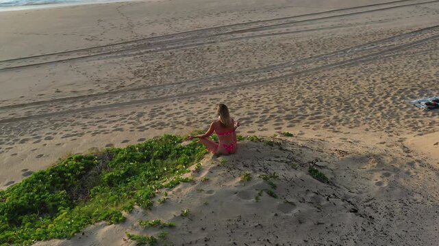 Aerial Drone View of Woman Meditating on Polihale Beach, Kauai