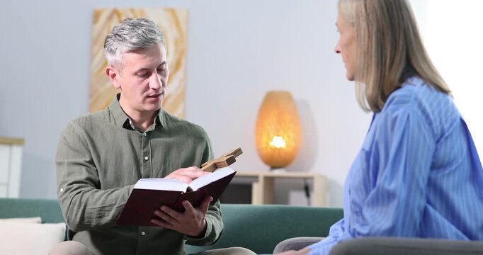 Pastor conducting Bible study with senior woman at home