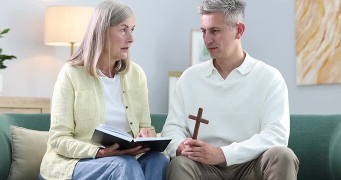 Pastor conducting Bible study with senior woman at home