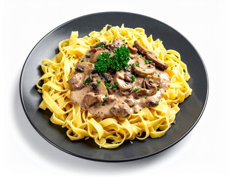 cooked spaghetti pasta with creamy mushroom sauce and fresh green herbs