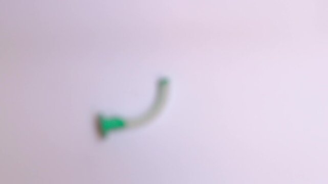 Set of colorful oropharyngeal airway tubes in different sizes arranged on white background, medical equipment for airway management