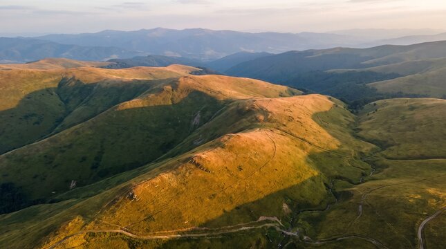 Grassy highlands and rolling hills stretch into the distance under a clear sky