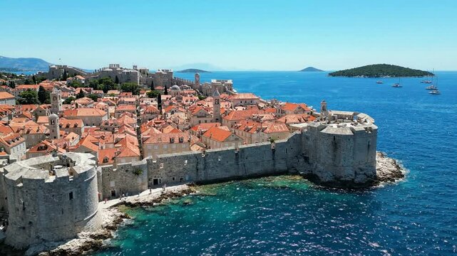 Croatian flag waving over dubrovnik old town walls and adriatic sea coastline