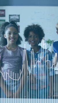 Animation of graphs over happy diverse smiling children standing and jumping in classroom