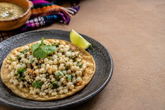 Traditional Mexican escamoles ant larvae served on corn tortilla with lime and copy space