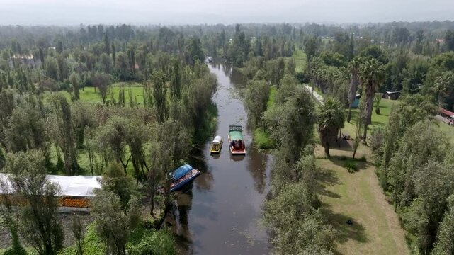 Aerial view of colorful trajineras boats and canals on a pier in Xochimilco in Mexico City