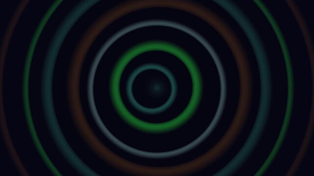Concentric rings of green, brown and teal glow against a dark background