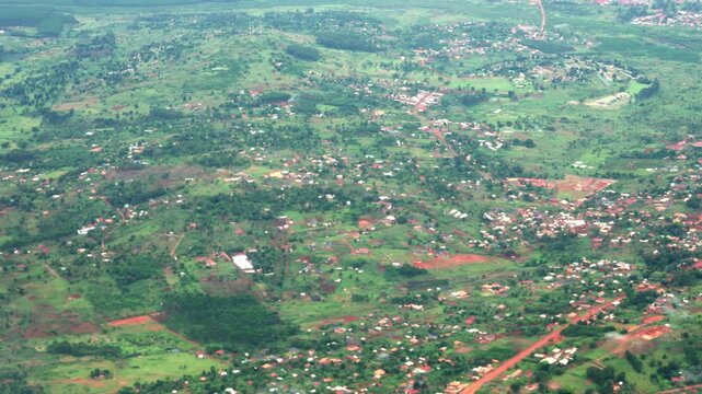 Aerial view of lush green landscape and rural residential settlement in Africa.