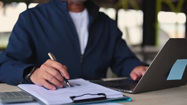 Businessman conducts financial analysis inside corporate office, executing investment analysis as expert performs budget analysis in investment management.